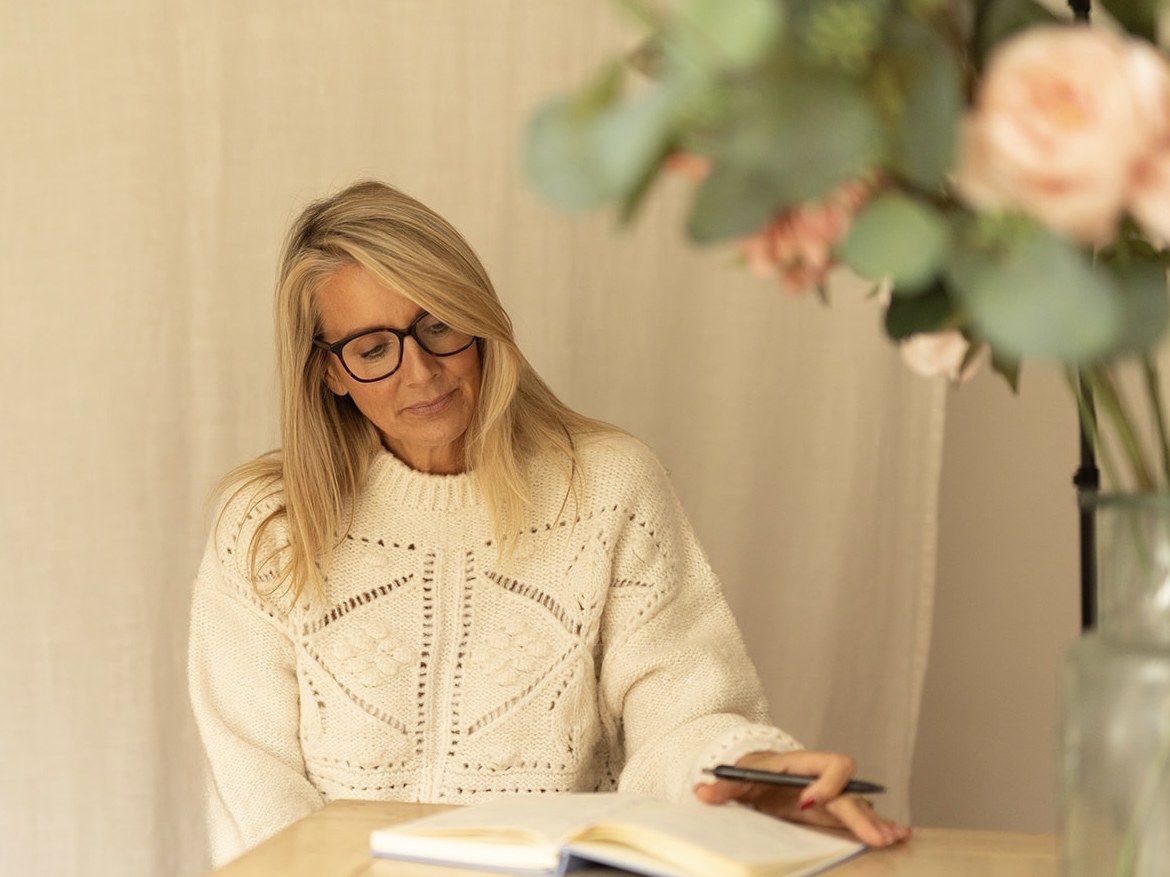 Nicola writing in a journal during a Reset Wellness session